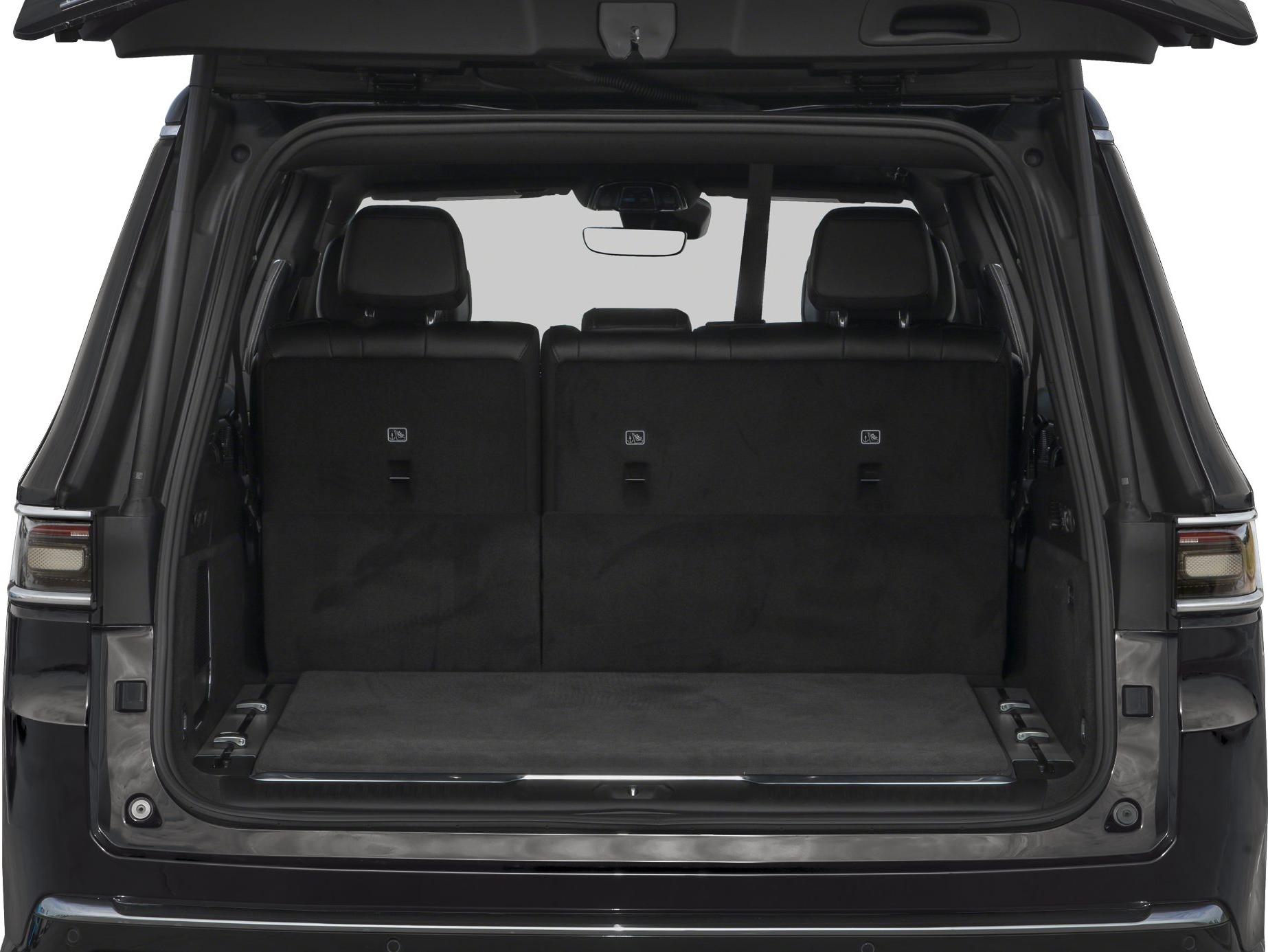 Spacious rear cargo area with upright foldable seats and black interior upholstery