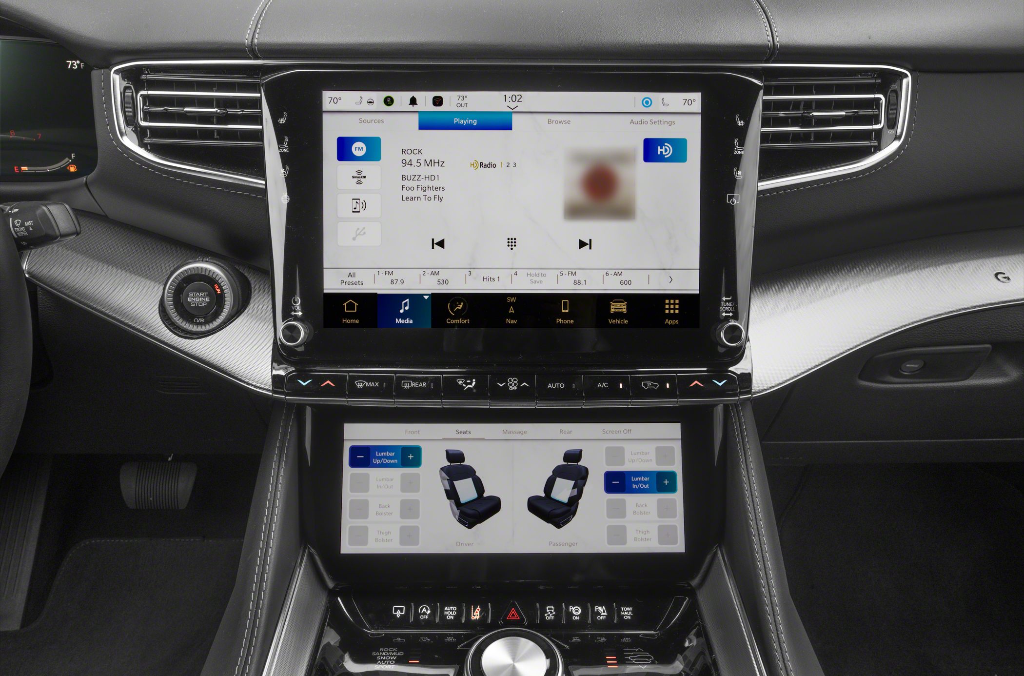 Dual touchscreen infotainment and seat adjustment controls in luxury SUV interior