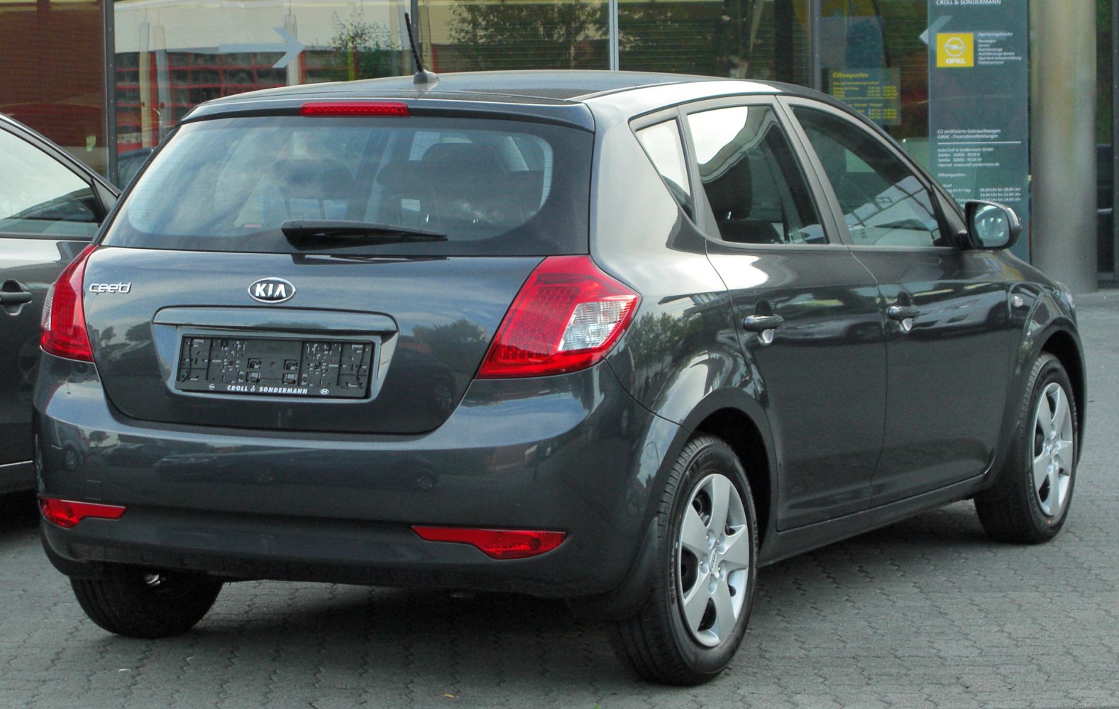 Rear view of five-door hatchback with taillights and rear window wiper