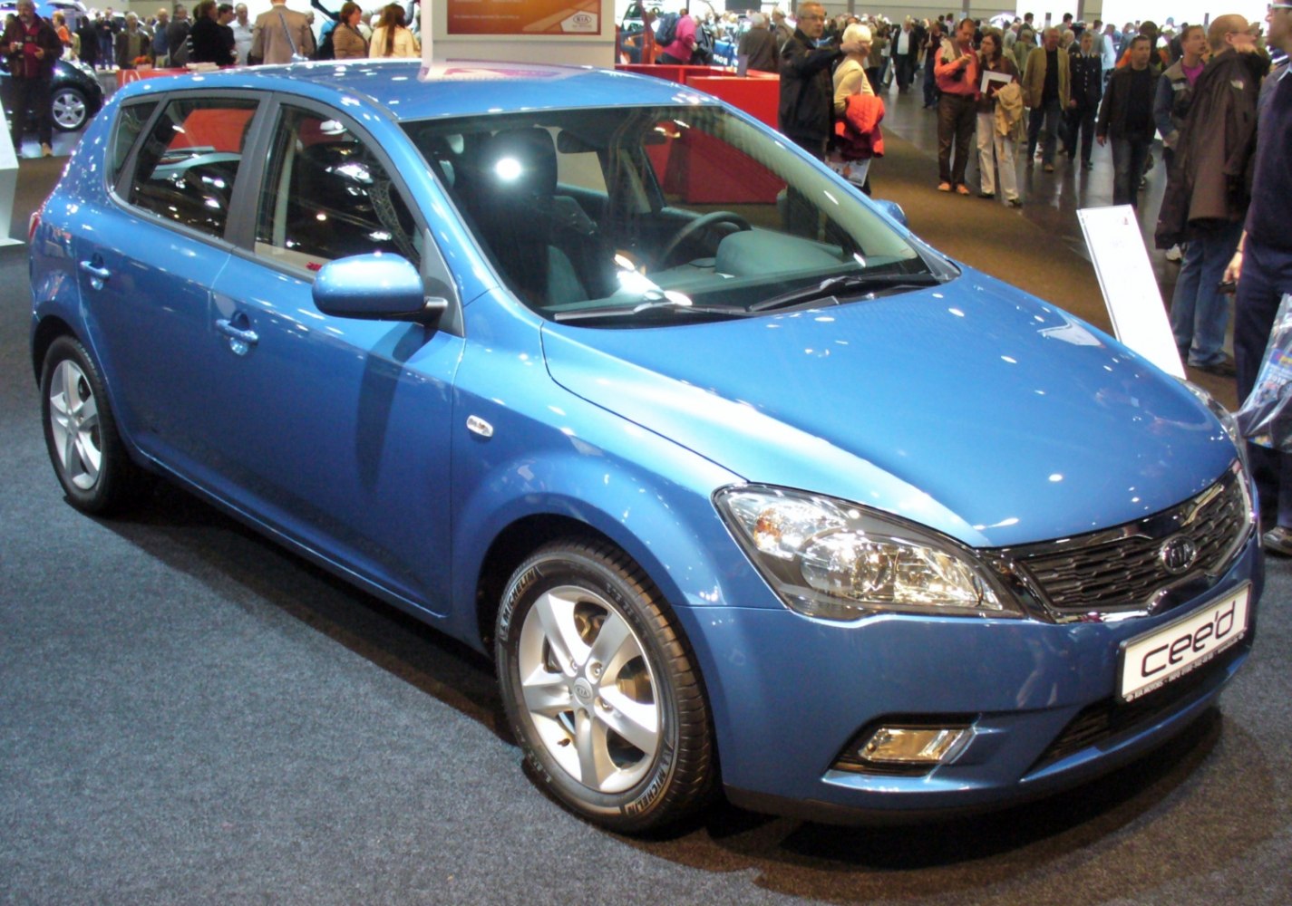 Blue 5-door hatchback with facelifted front and alloy wheels