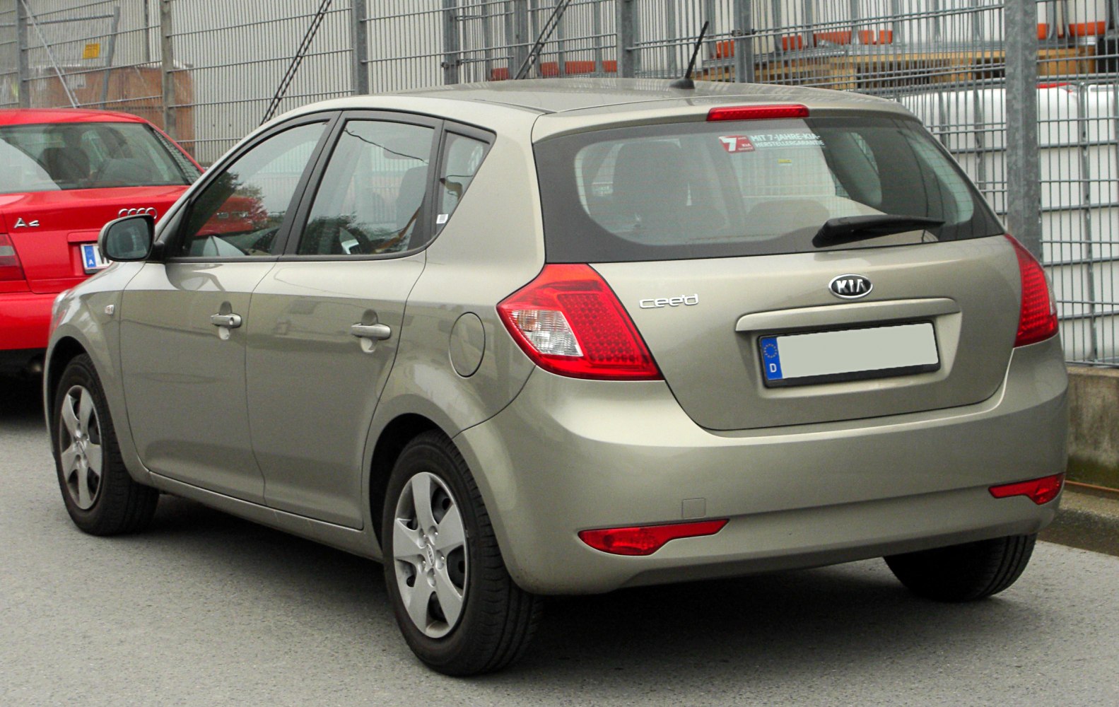 Rear side view of hatchback with distinct tail lights and rear window.