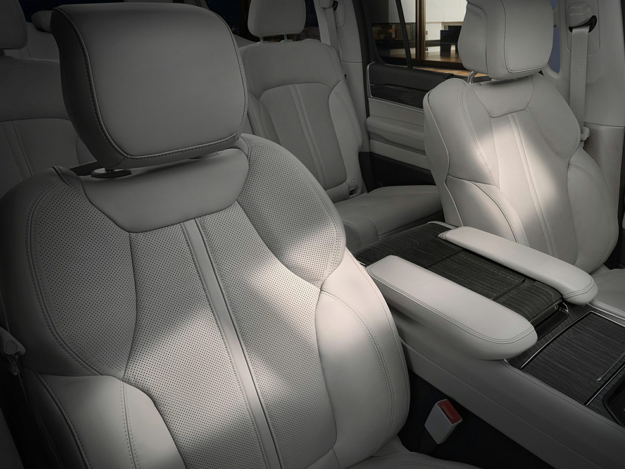 Light gray perforated leather front seats with center console and armrest