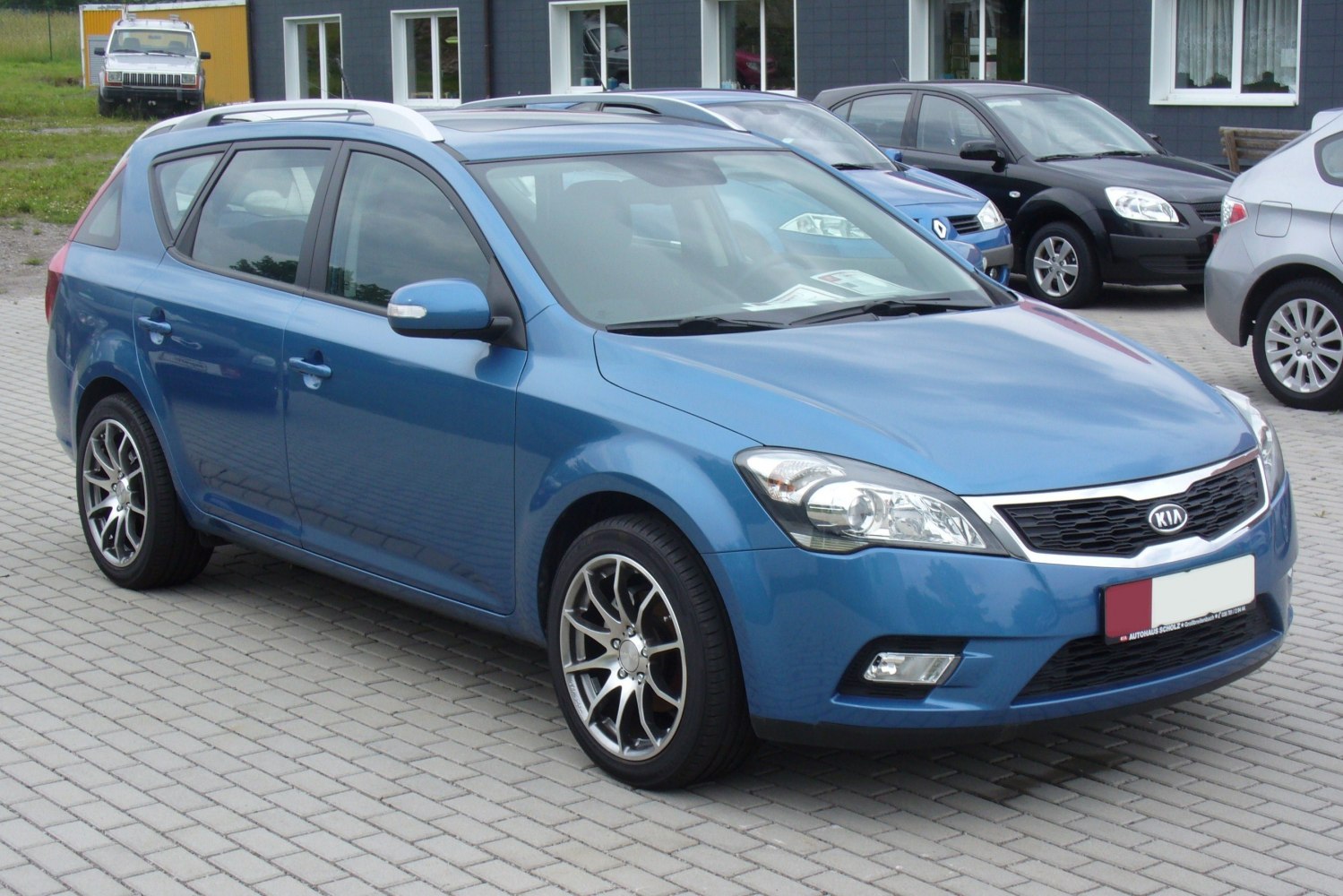 Blue estate vehicle with alloy wheels and roof rails