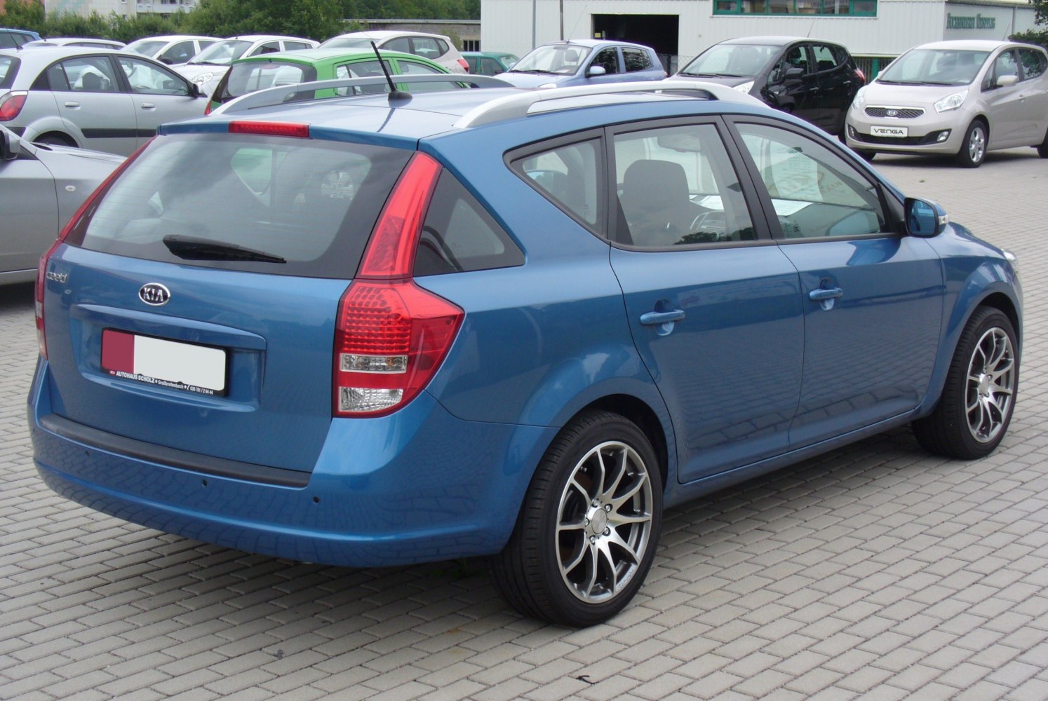 Rear and side view of an estate with distinct vertical tail lights and alloy wheels