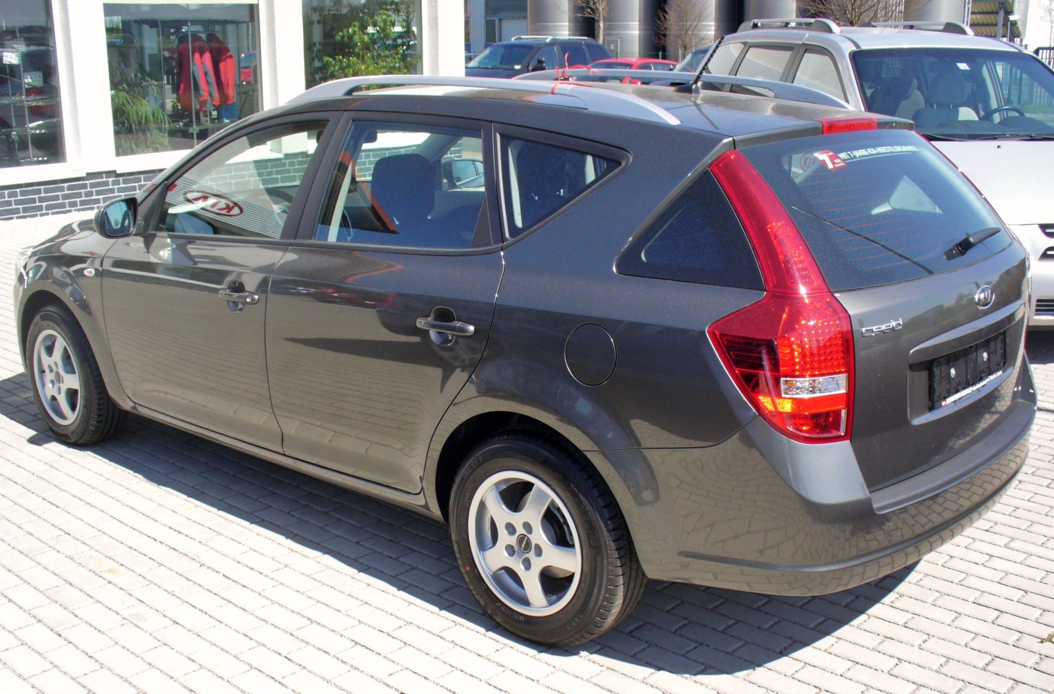 Side and rear view of a facelifted station wagon with distinctive taillights and roof rails.