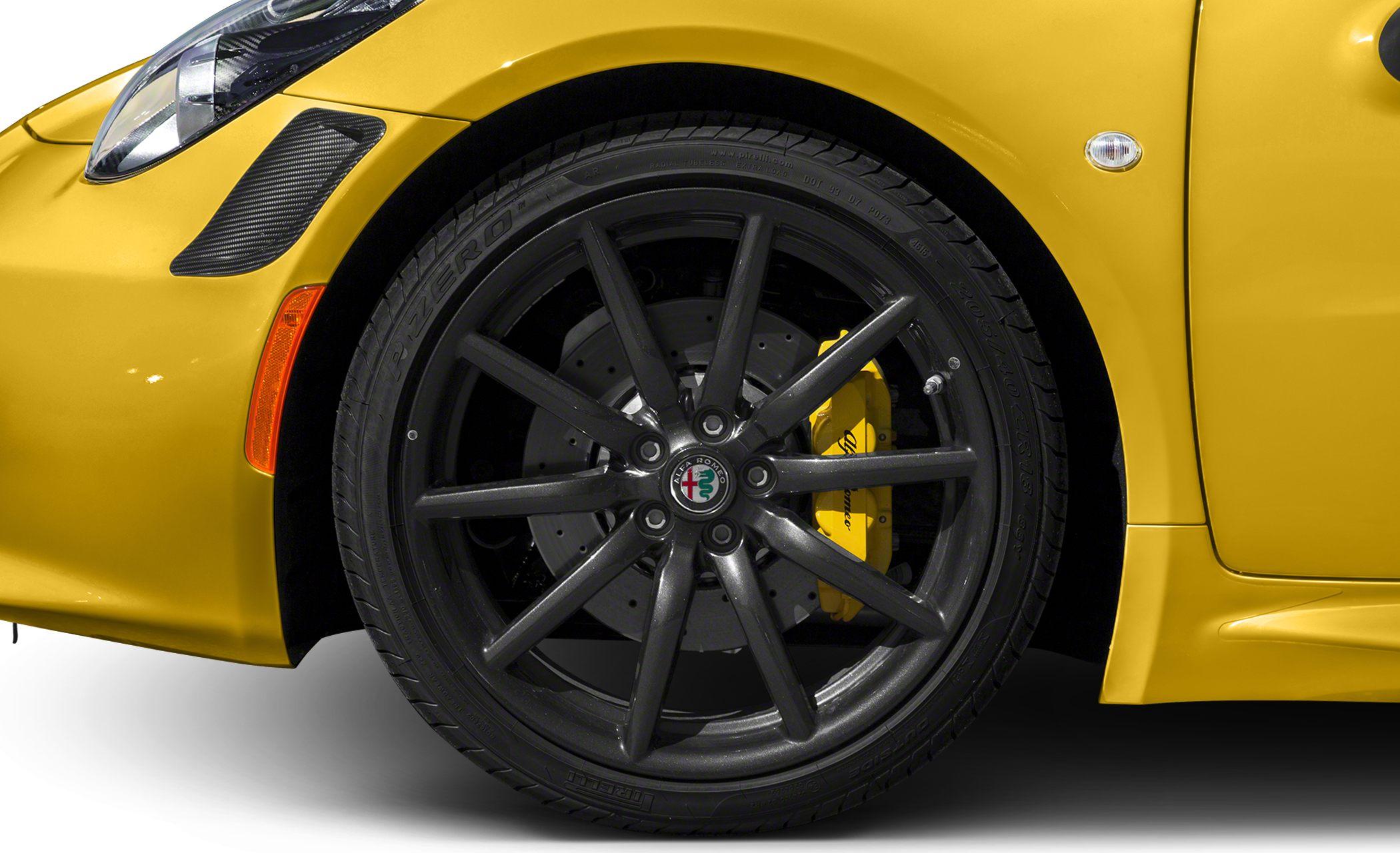 Black alloy wheel with yellow brake caliper and perforated disc