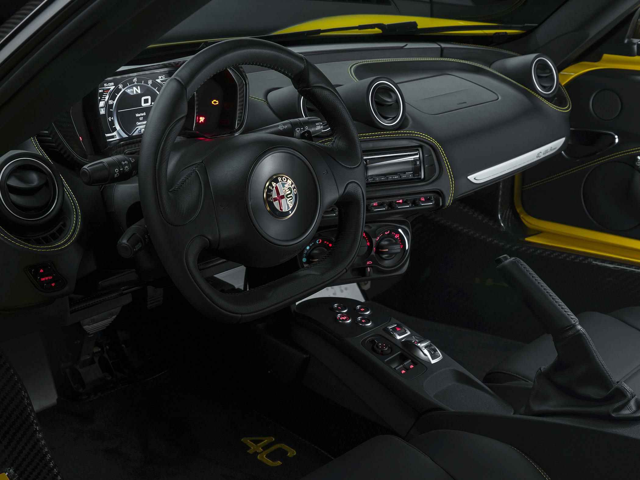 Sporty dashboard and steering wheel with digital display and leather stitching