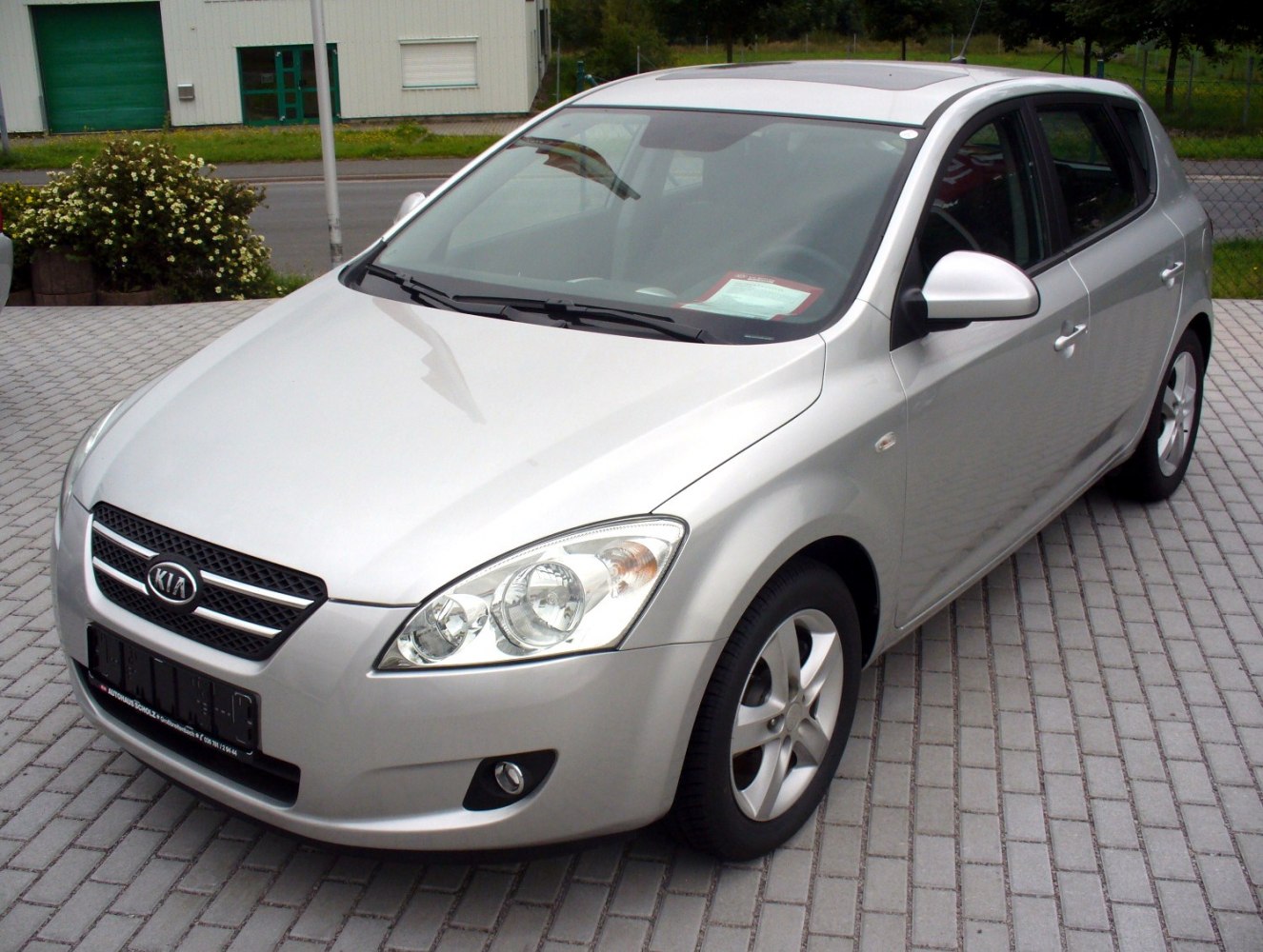 Silver 5-door hatchback front view with alloy wheels and clear headlamps