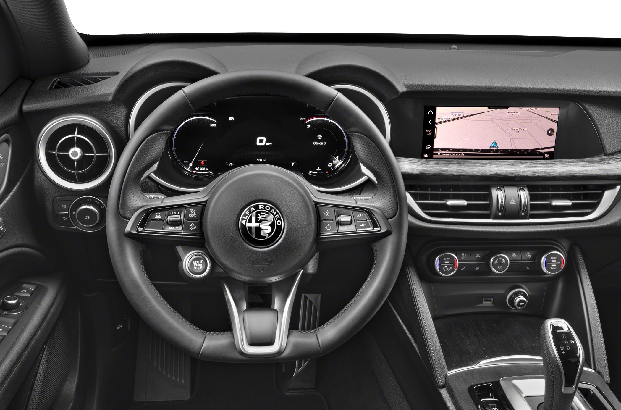 Steering wheel, digital instrument cluster, infotainment screen, HVAC controls, gear selector