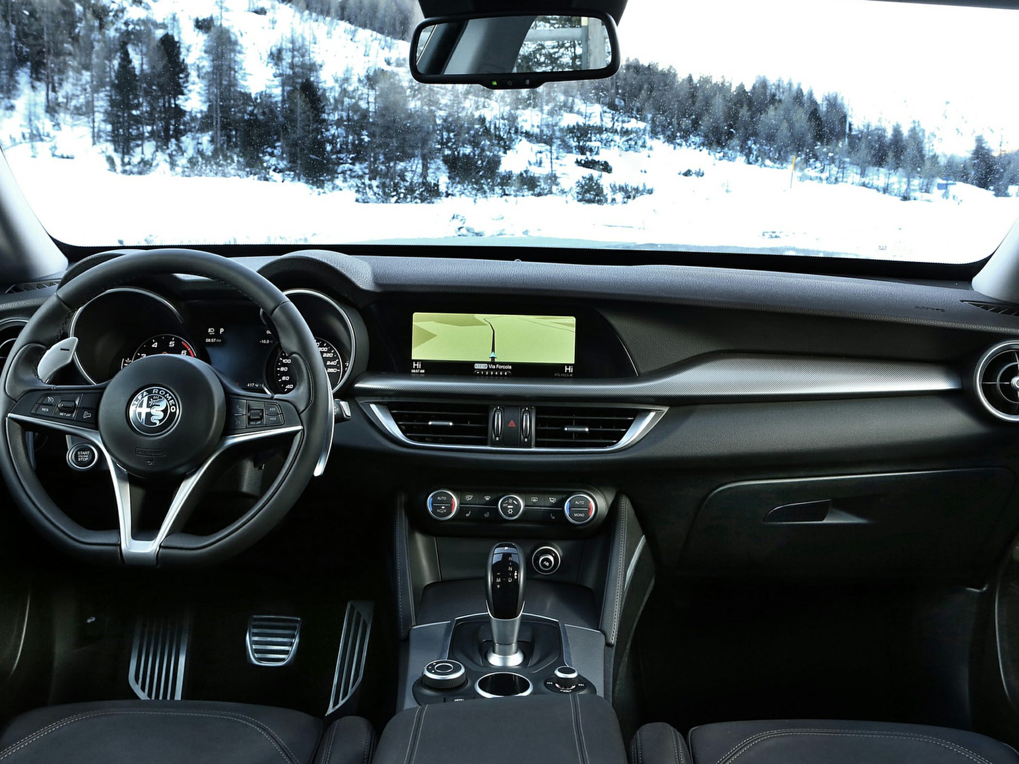 Modern car interior with dashboard, steering wheel, and digital navigation display