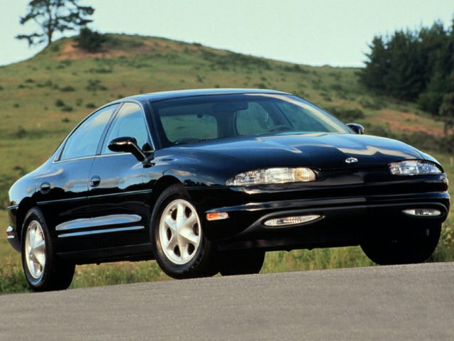 Front view of a black sedan with sleek headlights and smooth curves