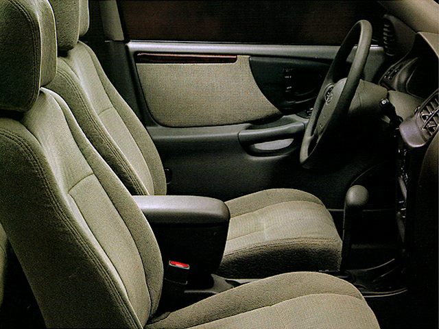 Front fabric seats and door panel interior with armrest and steering wheel