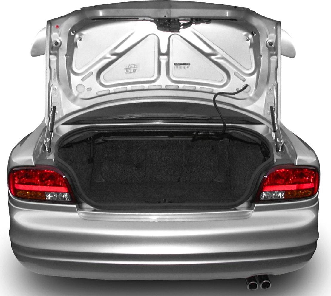 Open rear trunk with dual exhaust tips on a sedan.