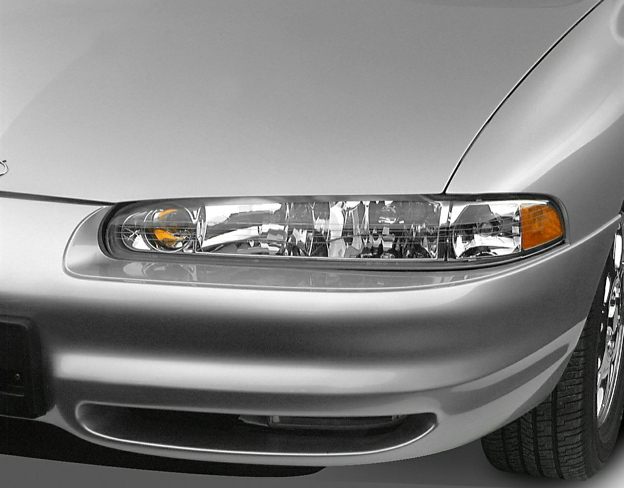 Close-up of front headlight and grille with part of front bumper