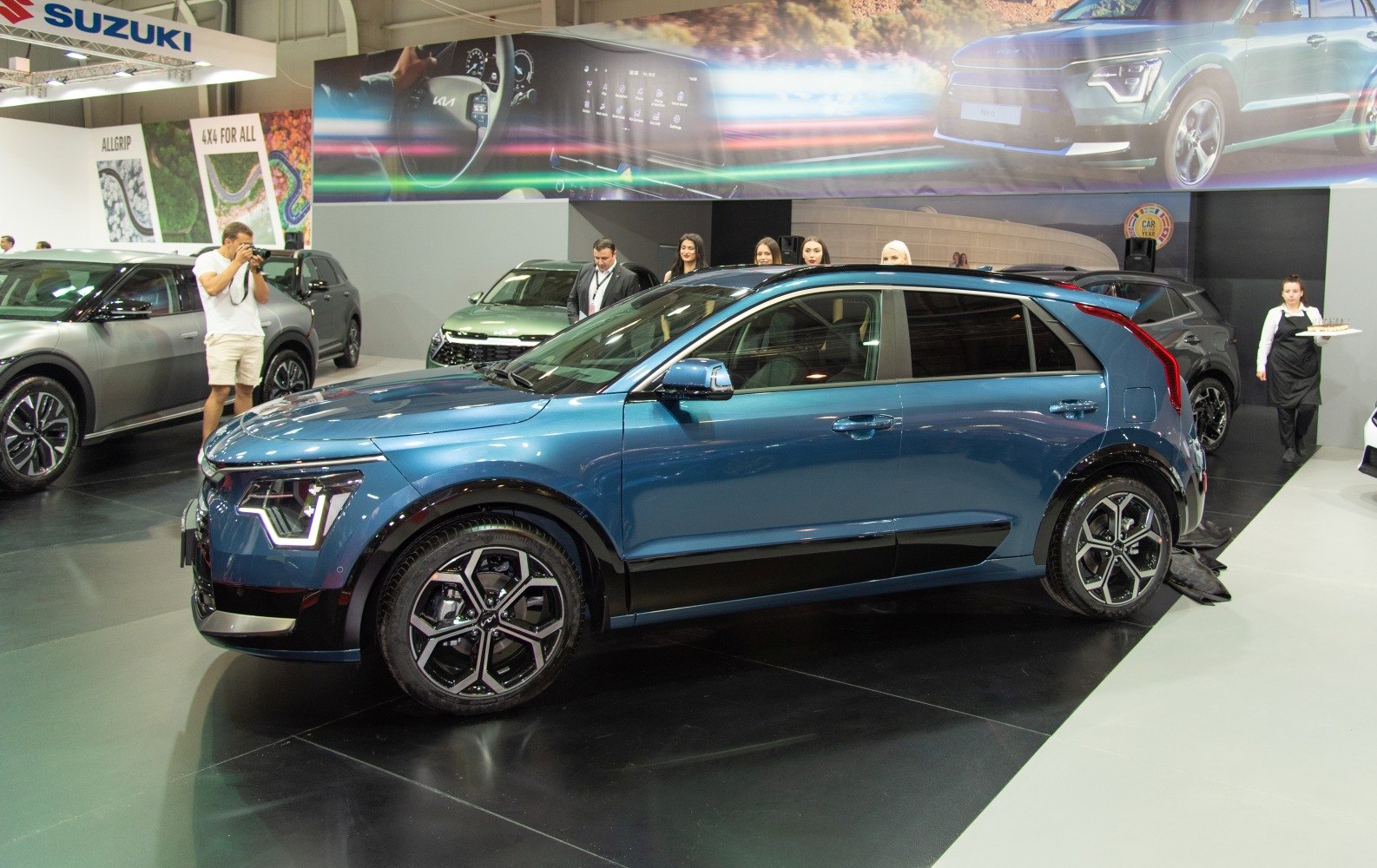 Modern blue electric SUV with distinctive LED headlights and geometric alloy wheels.