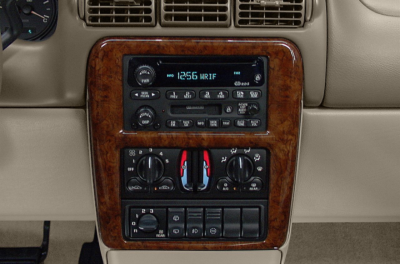Dashboard radio and climate control panel with wood trim