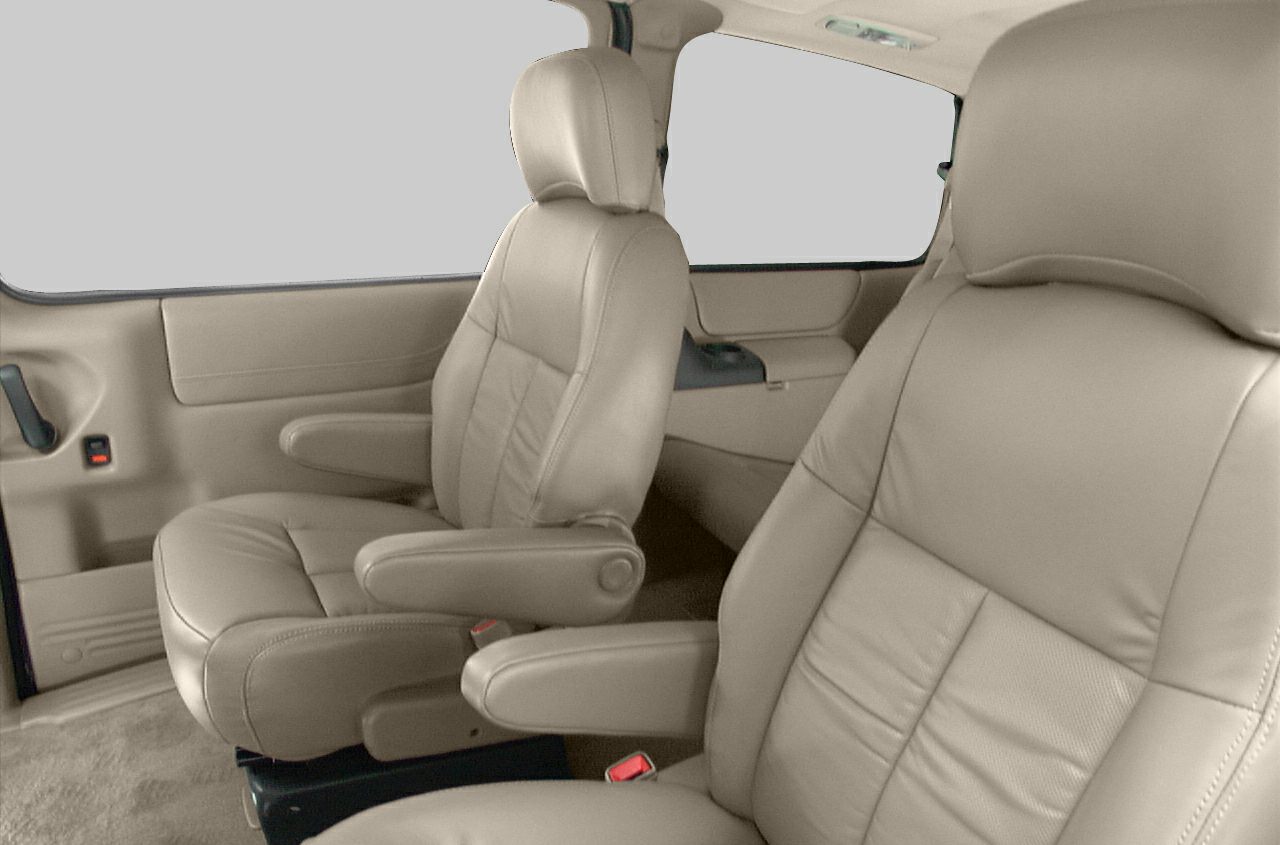 Tan leather front seats with armrests inside a vehicle
