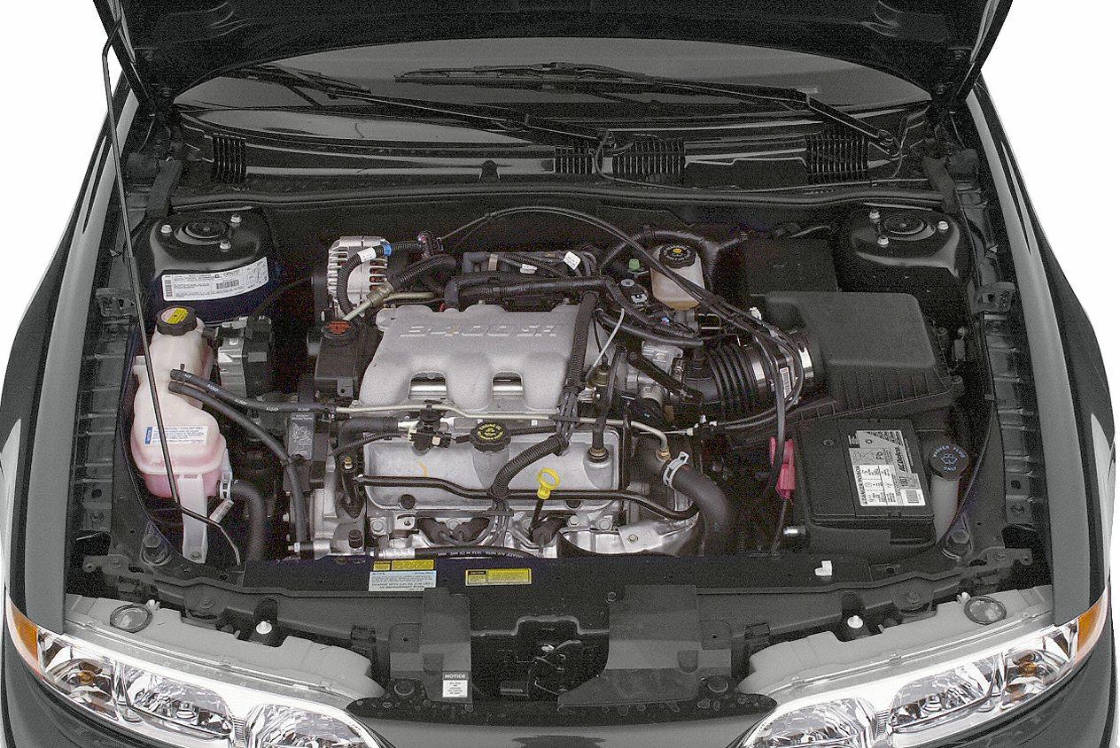 Engine bay with visible engine and components under opened hood