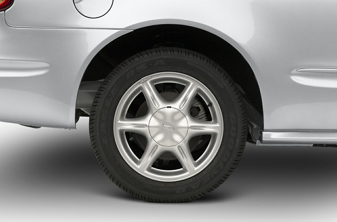 Close-up of silver alloy wheel with Goodyear tire on a car.