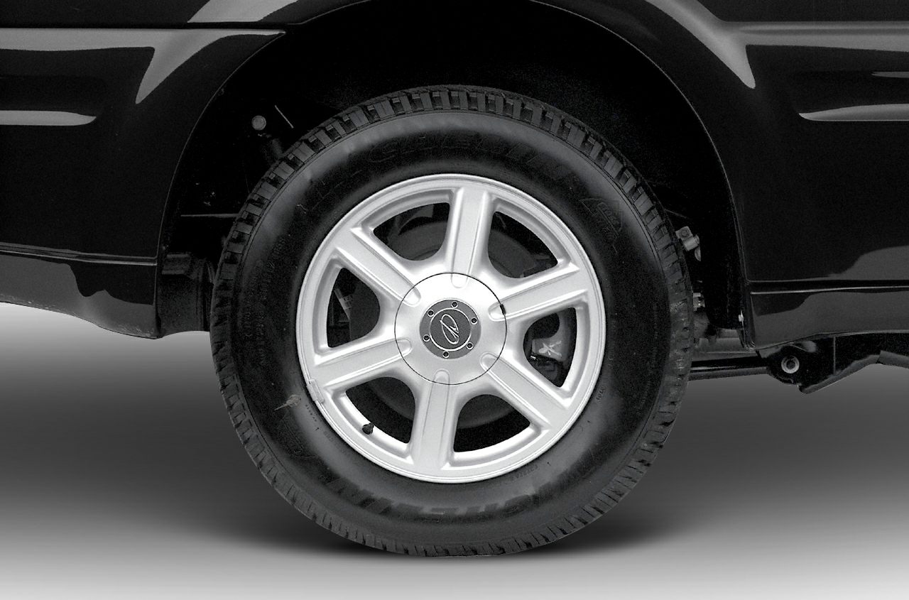 Silver 6-spoke alloy wheel with tire on vehicle