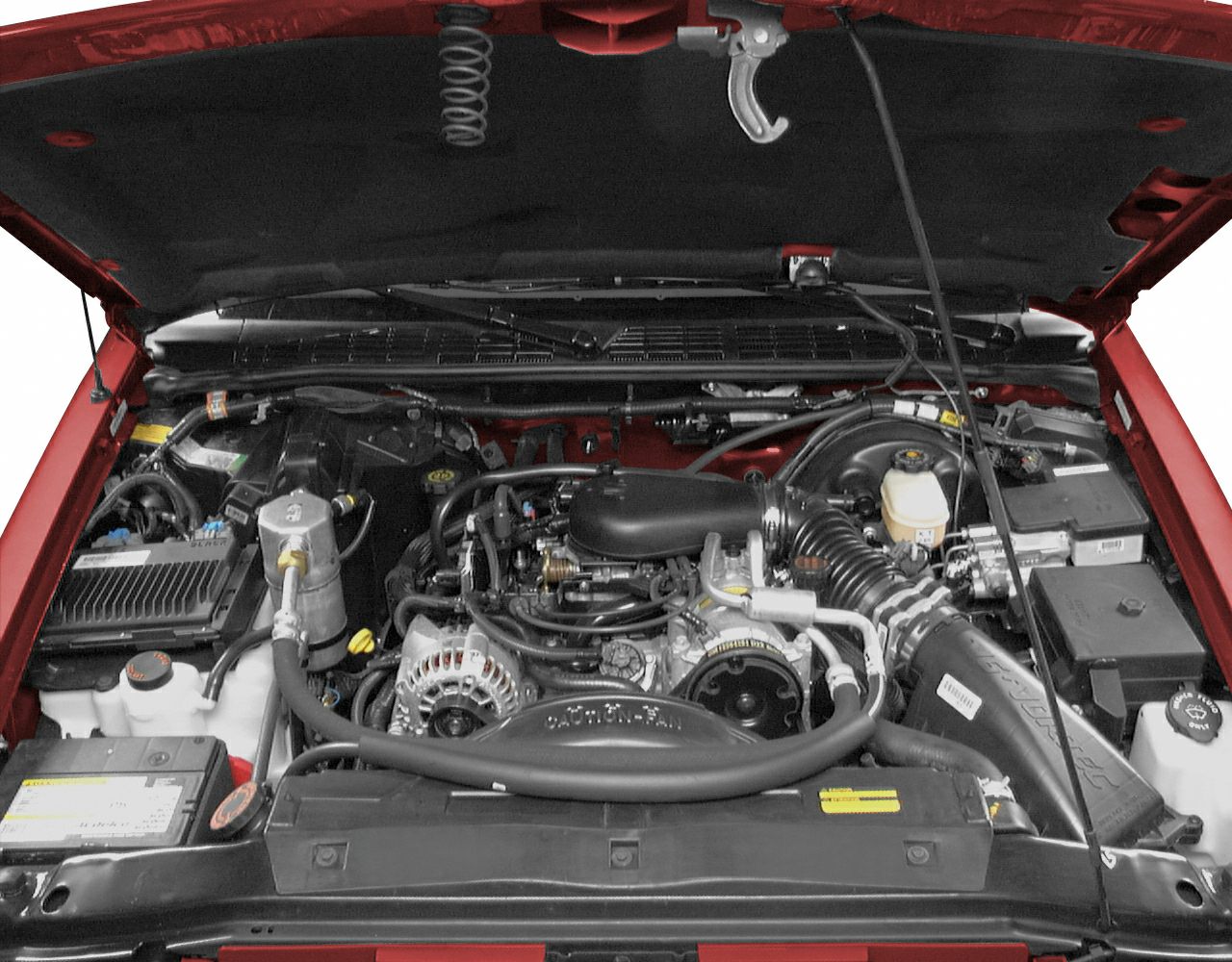 Open engine bay with mechanical components and fluid reservoirs