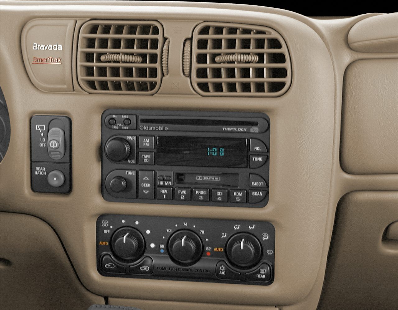 Beige car interior panel with air vents, audio system, and climate controls