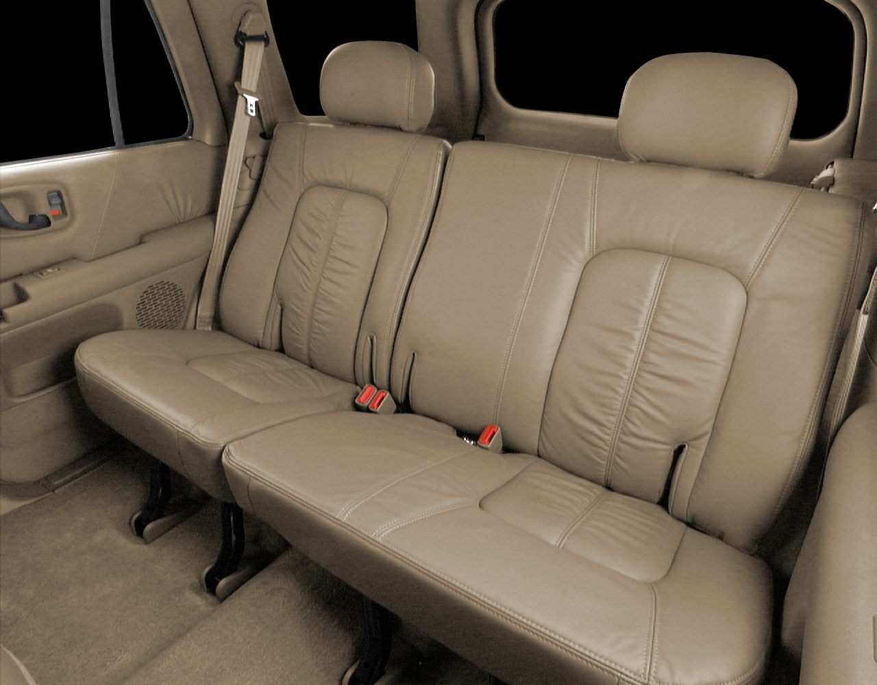 Beige leather rear seats with integrated headrests and seat belts