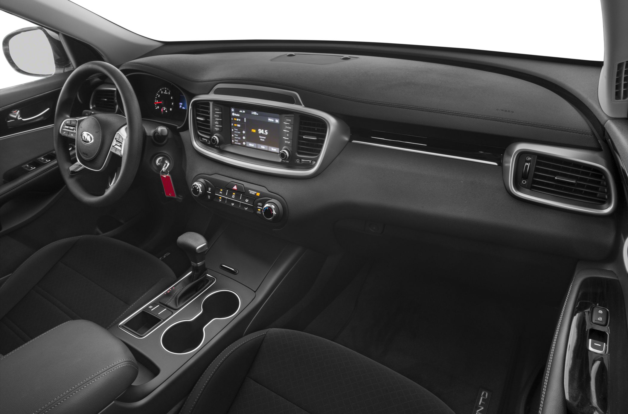 Dashboard, infotainment system, center console with gear shift and cup holders.