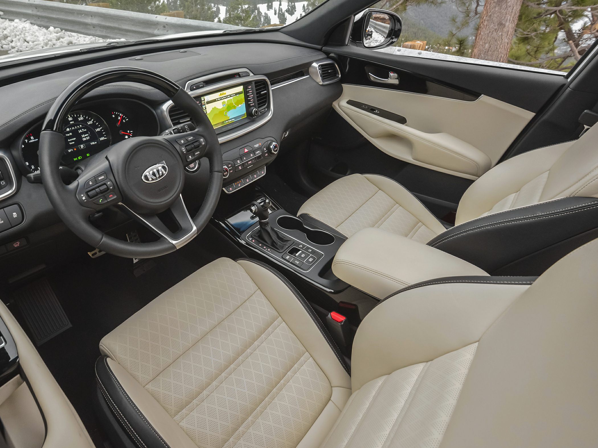 Interior dashboard with infotainment and beige quilted seats