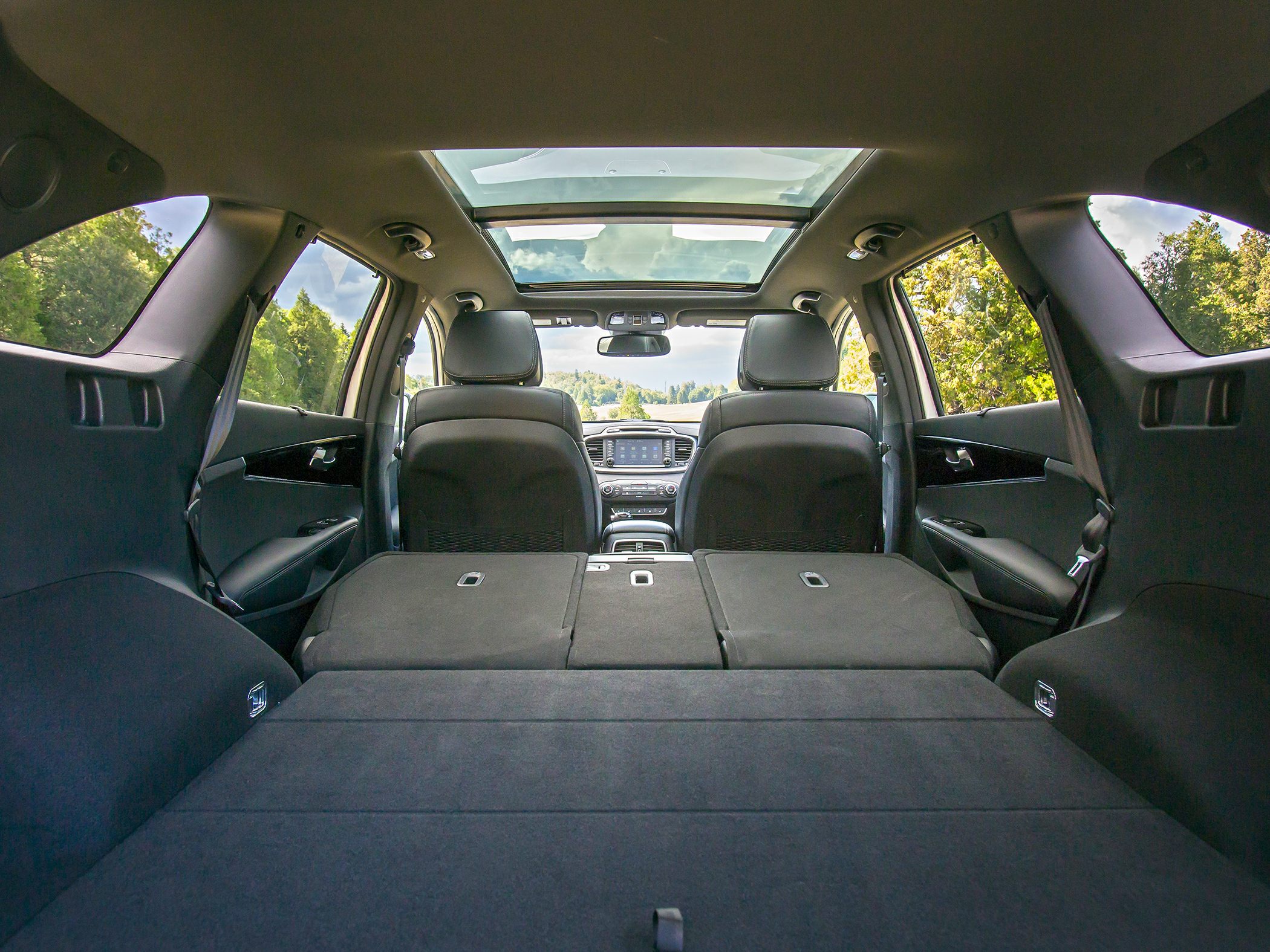 Folded rear seats and panoramic sunroof in spacious SUV interior