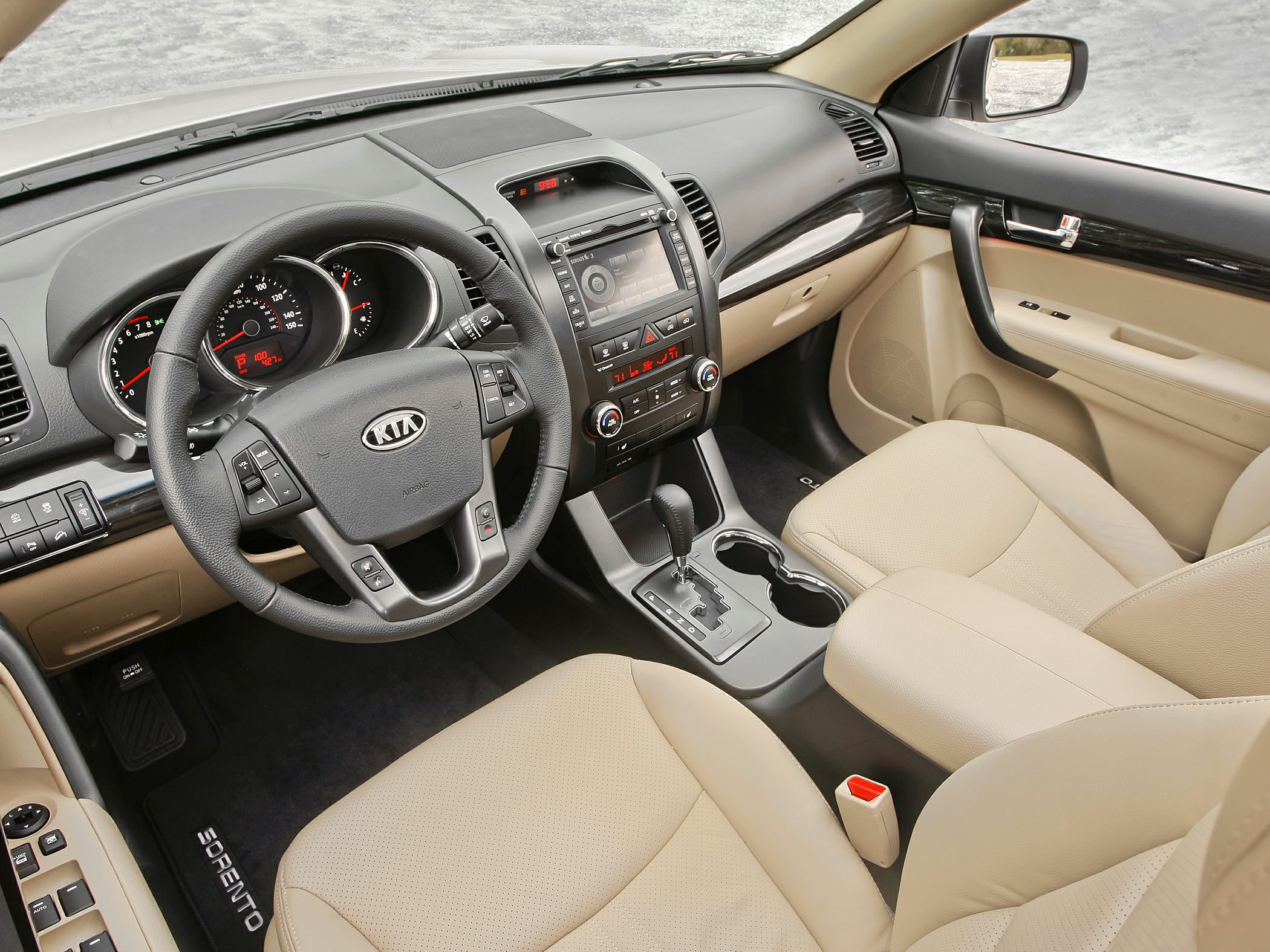Dashboard, steering wheel, center console, and beige leather seats