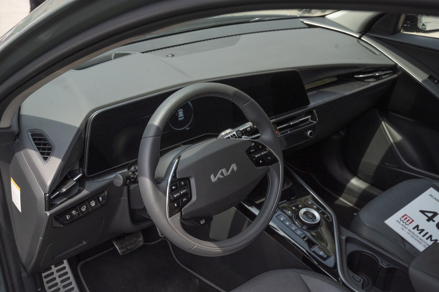 Modern digital dashboard and multifunction steering wheel in car interior