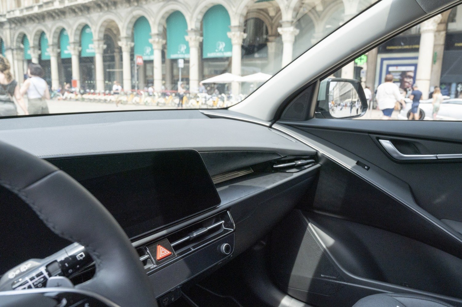 Modern car dashboard and passenger door panel with controls