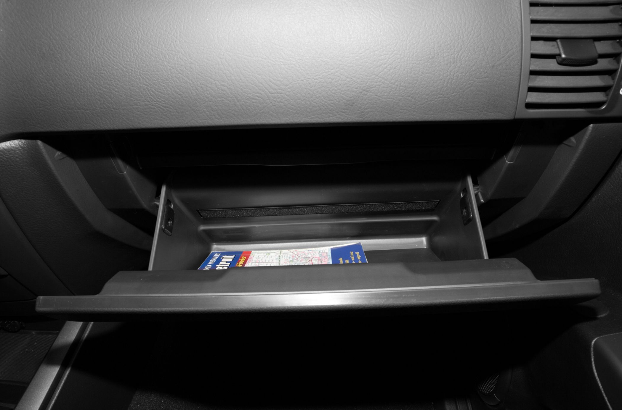 Open glove compartment with map booklet inside