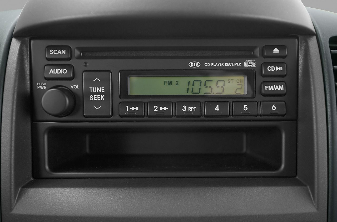 Car stereo with CD player, FM/AM radio, and tune seek control buttons.