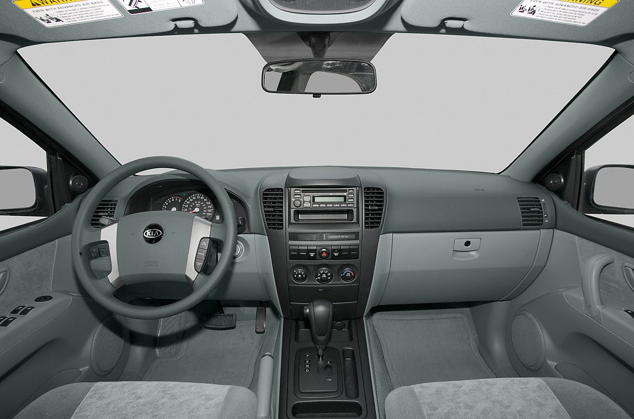 Steering wheel, dashboard, central console, and front seats interior.