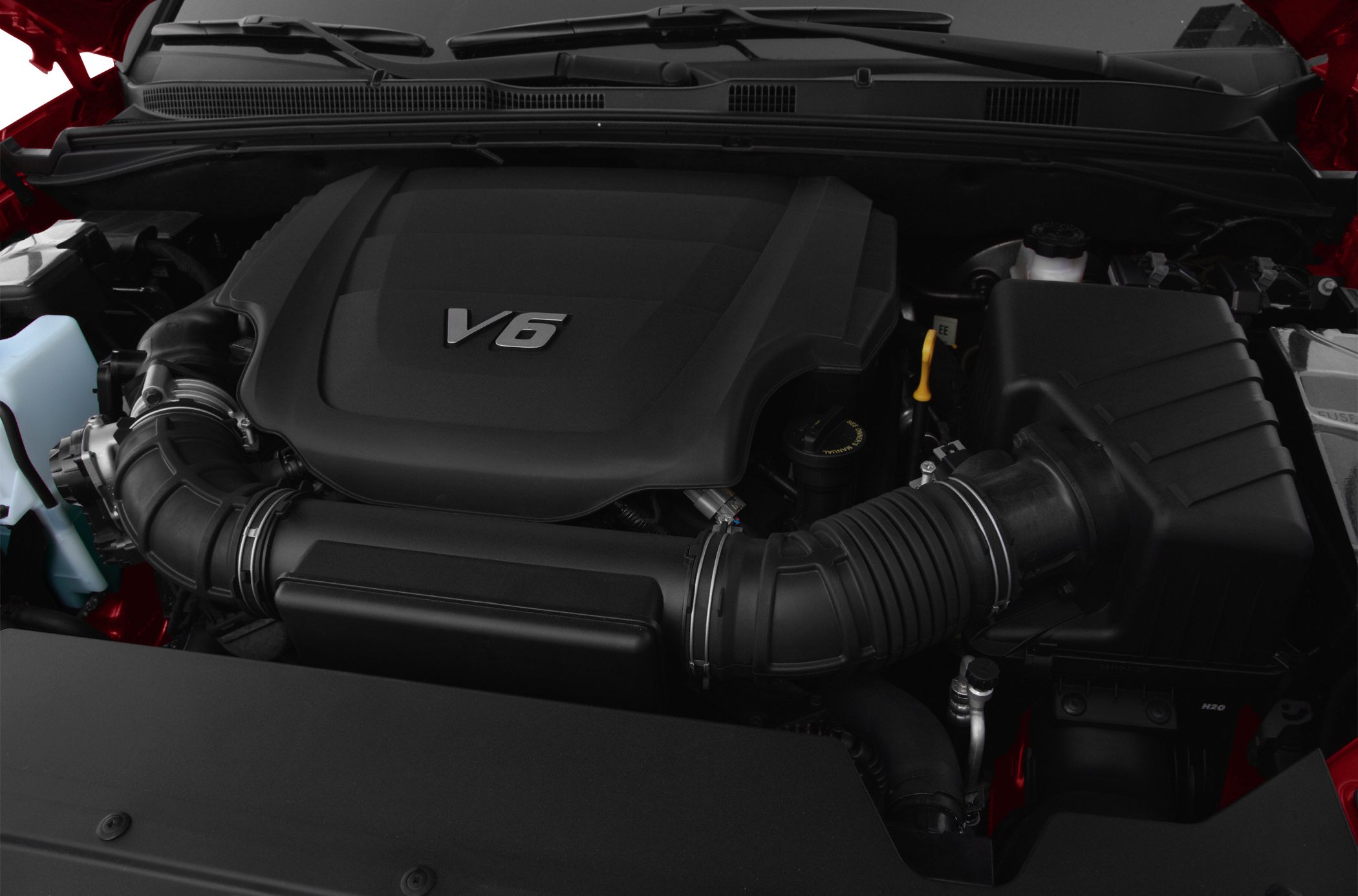 Close-up of a V6 engine with intake components and engine cover.