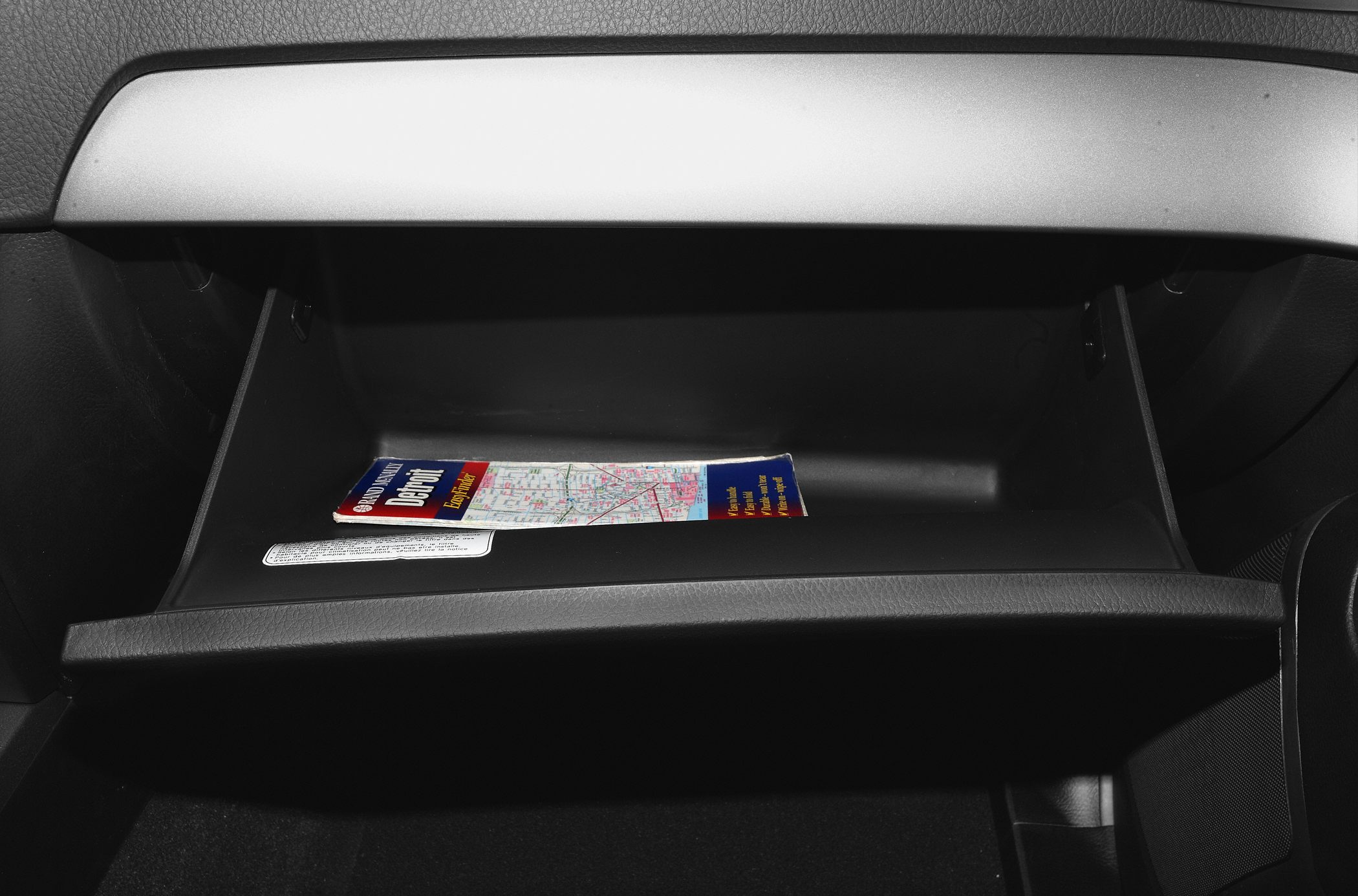Open glove compartment with a map inside