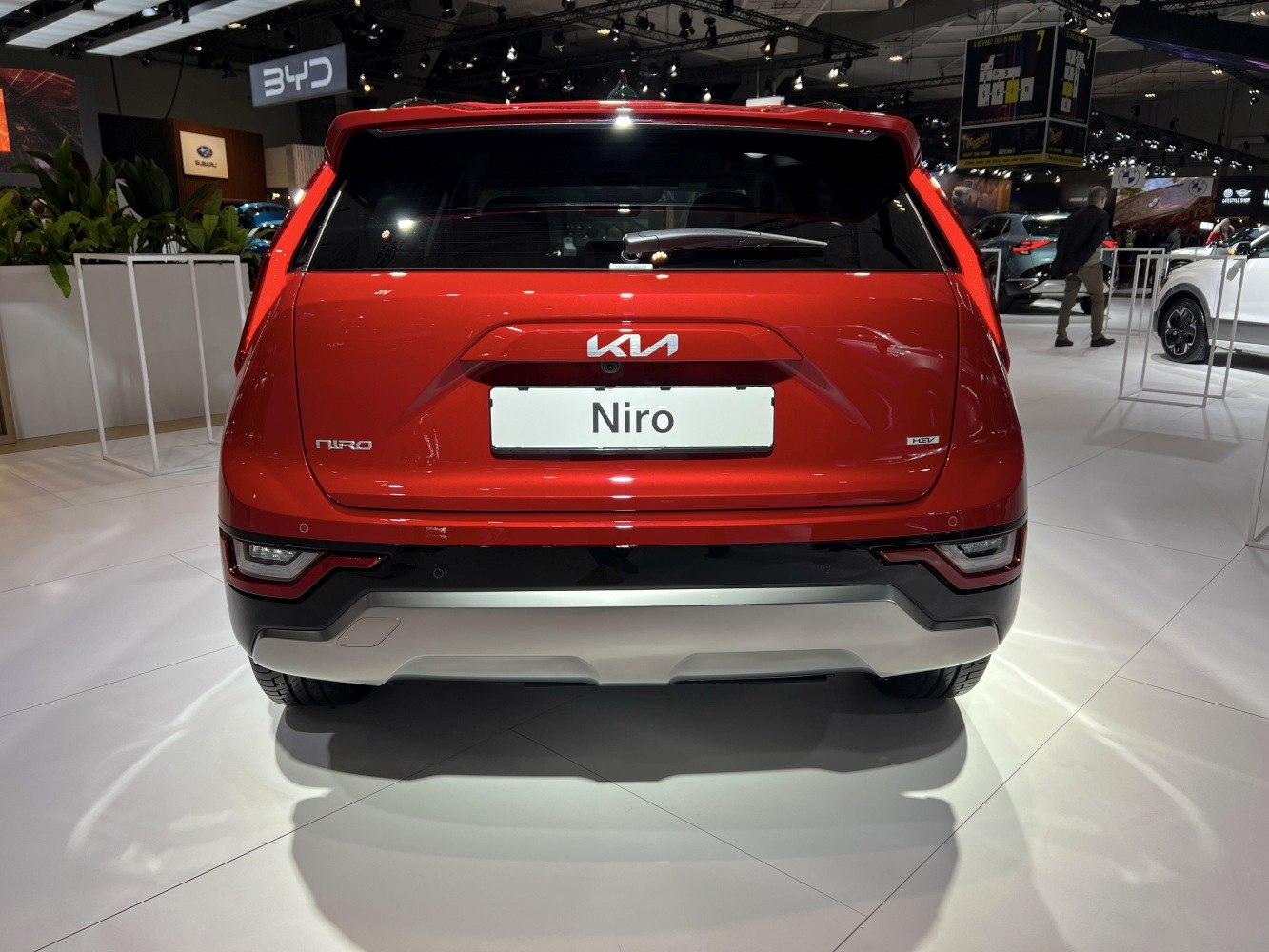 Red hatchback rear view with distinctive taillights and rear wiper.