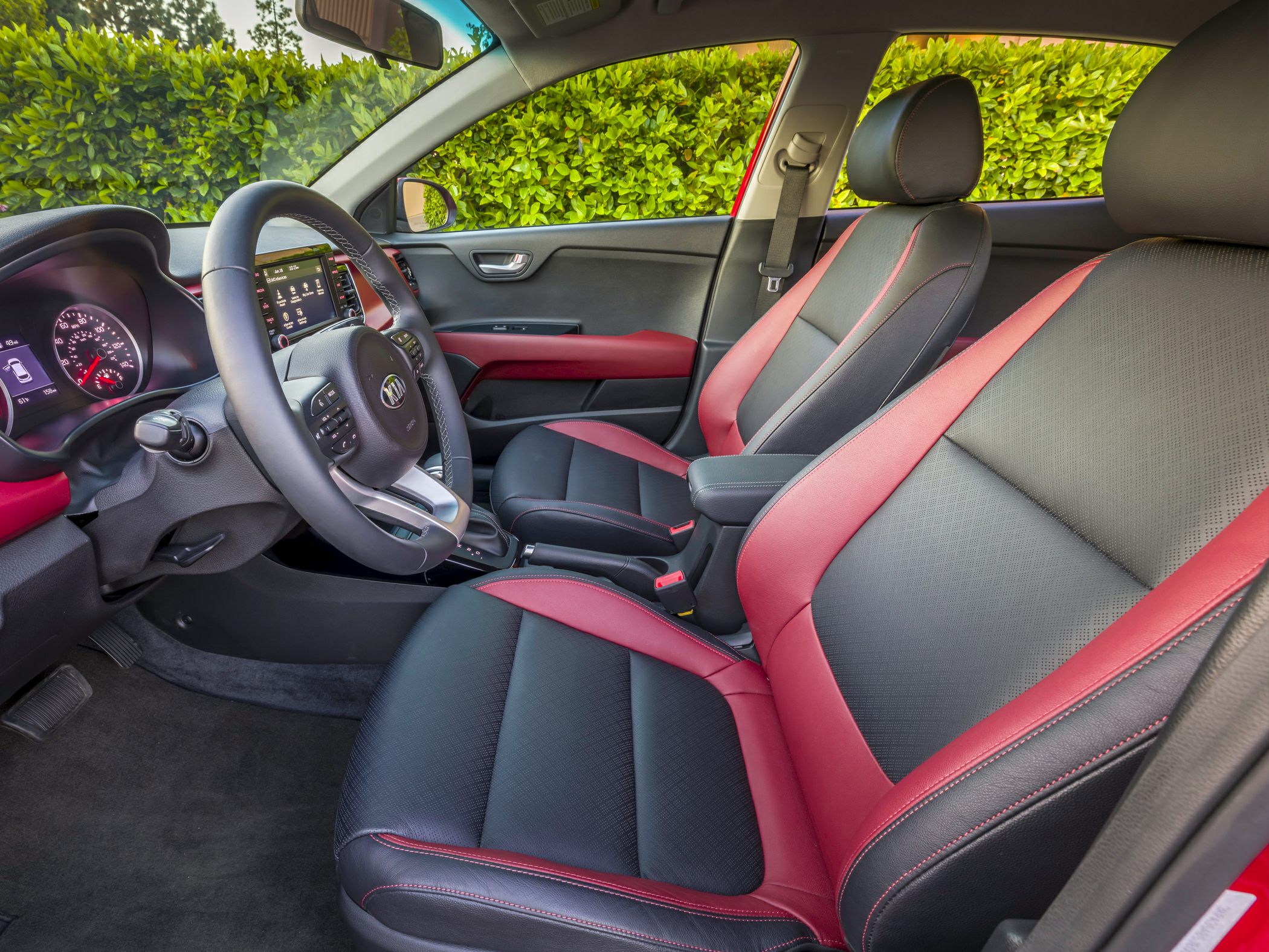 Two-tone red and black front seats with modern dashboard.