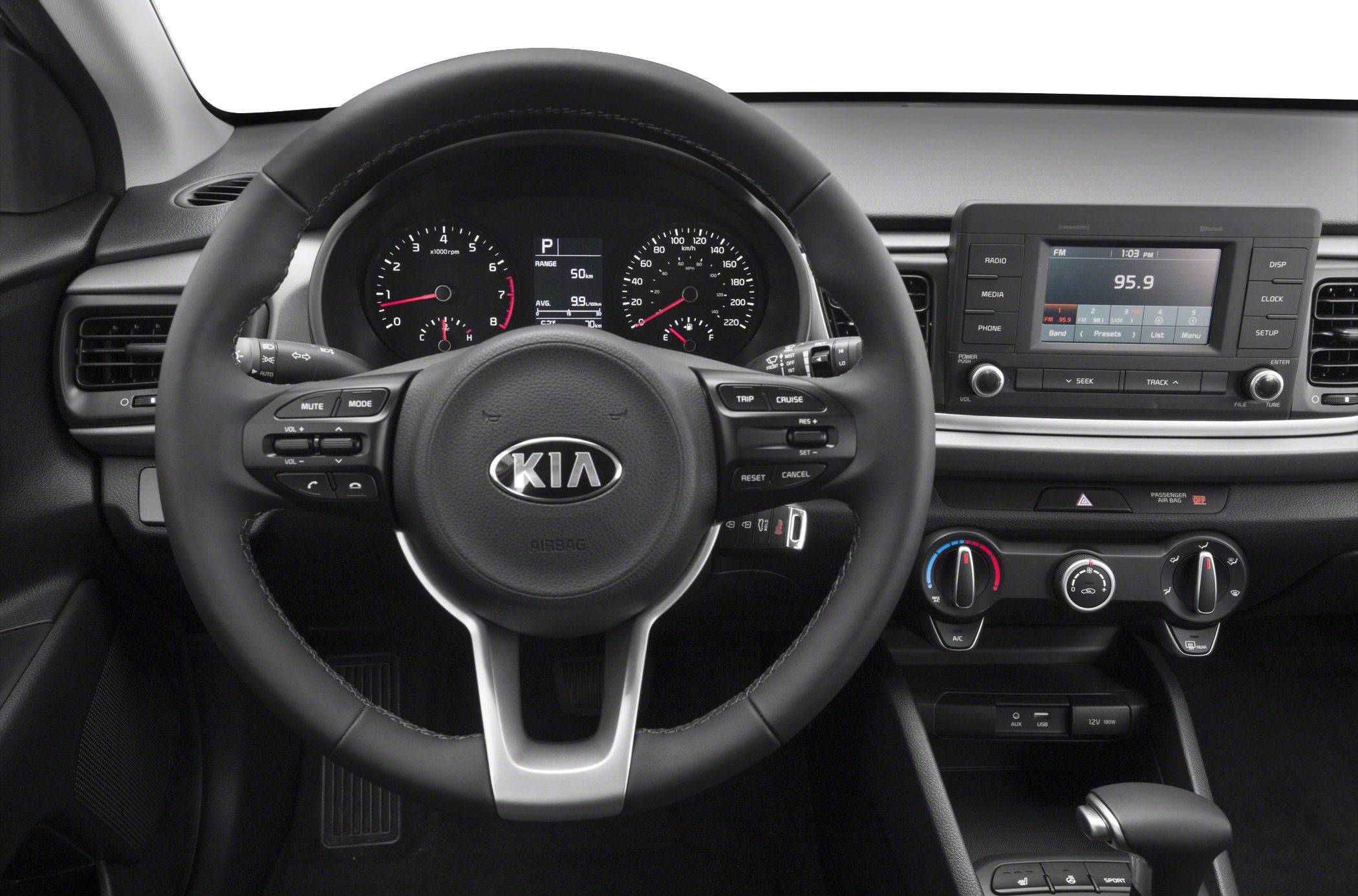 Steering wheel with controls, instrument cluster, and infotainment system.