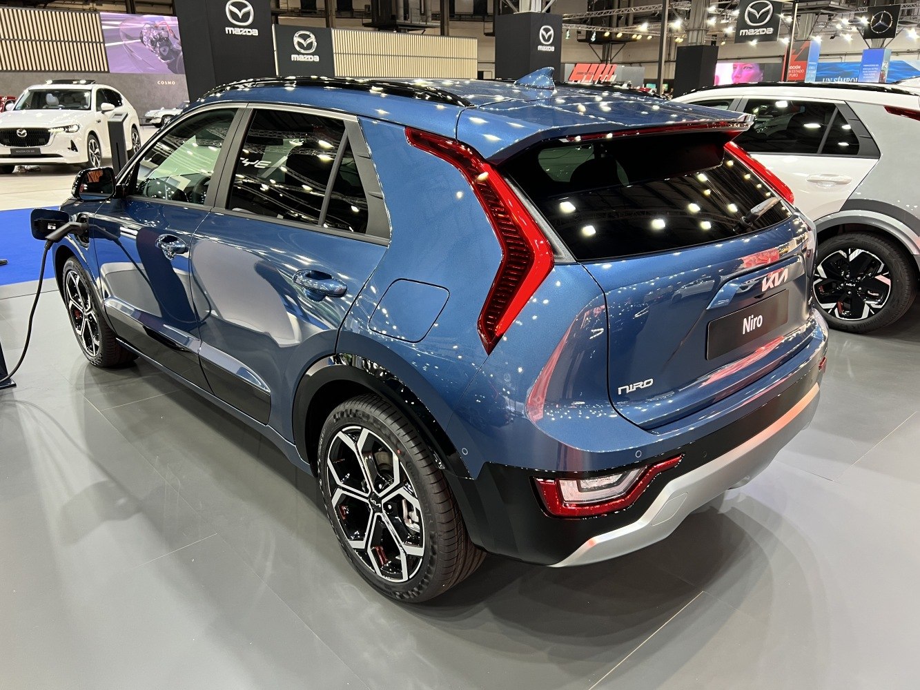 Rear view with distinctive LED taillights and charging port.