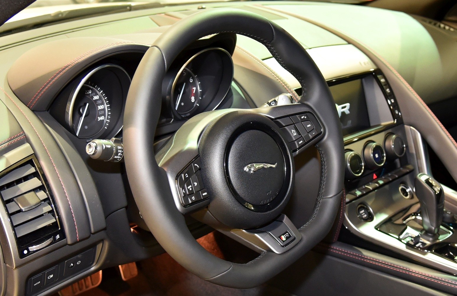 Sporty steering wheel with detailed instrument cluster in car interior