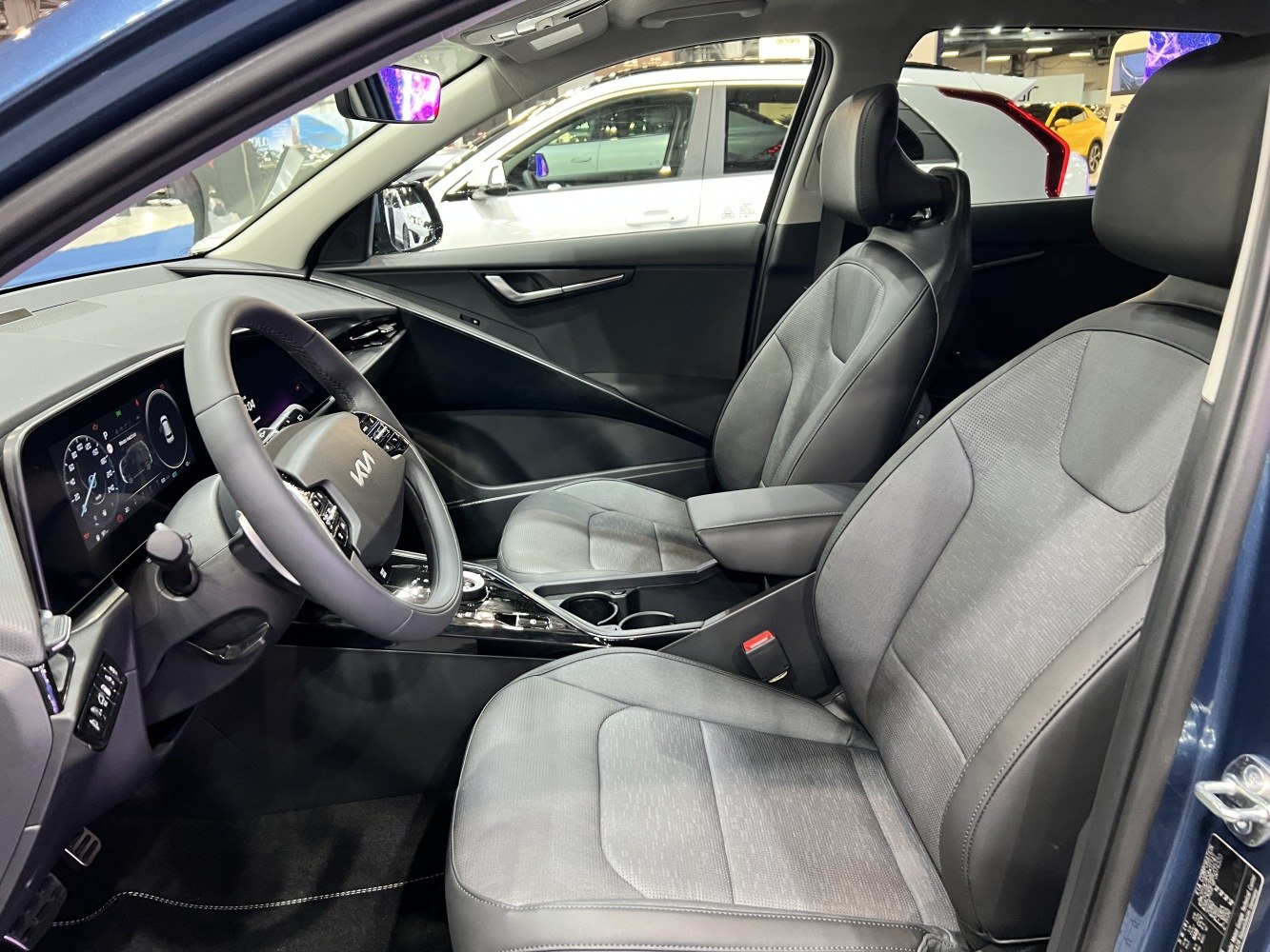 Modern dashboard with digital instrument cluster and ergonomic front seats.