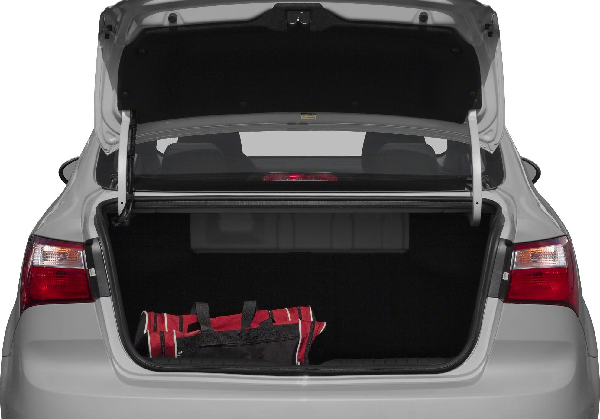 Open trunk of a sedan with visible rear seats and a bag inside