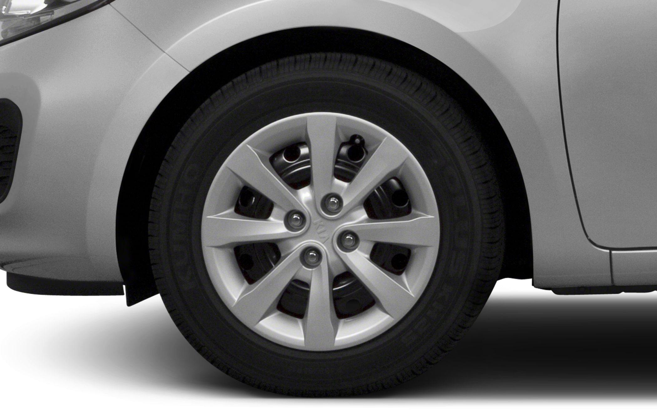Close-up of six-spoke alloy wheel and tire on hatchback vehicle