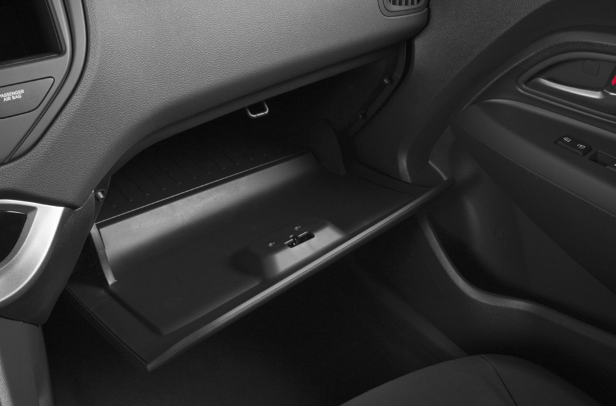 Open glove compartment with textured dashboard and door panel