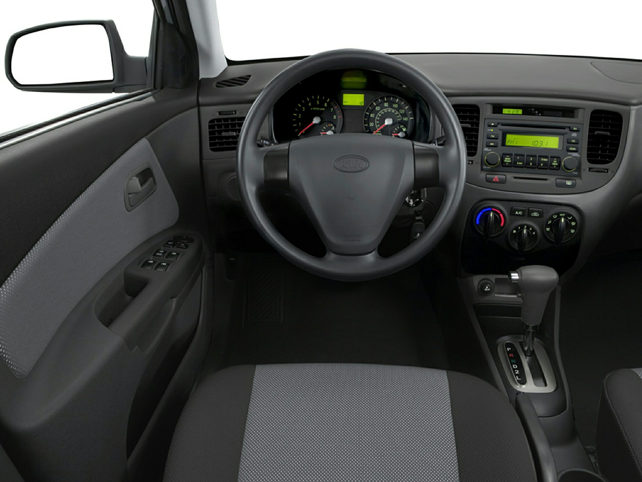 Steering wheel, automatic gear shift, dashboard controls in compact sedan interior