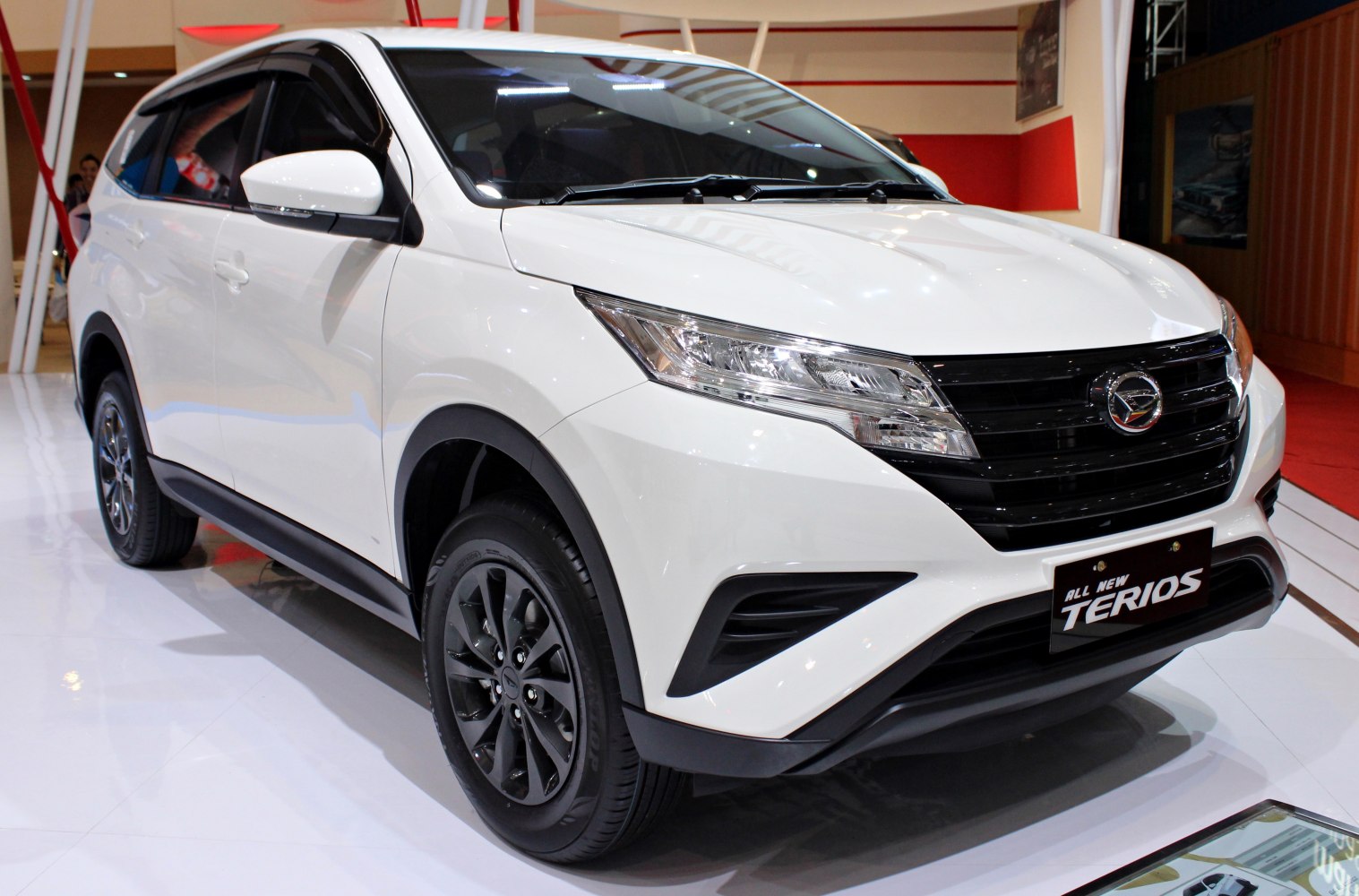 Front-side view of white SUV with LED headlights and black alloy wheels