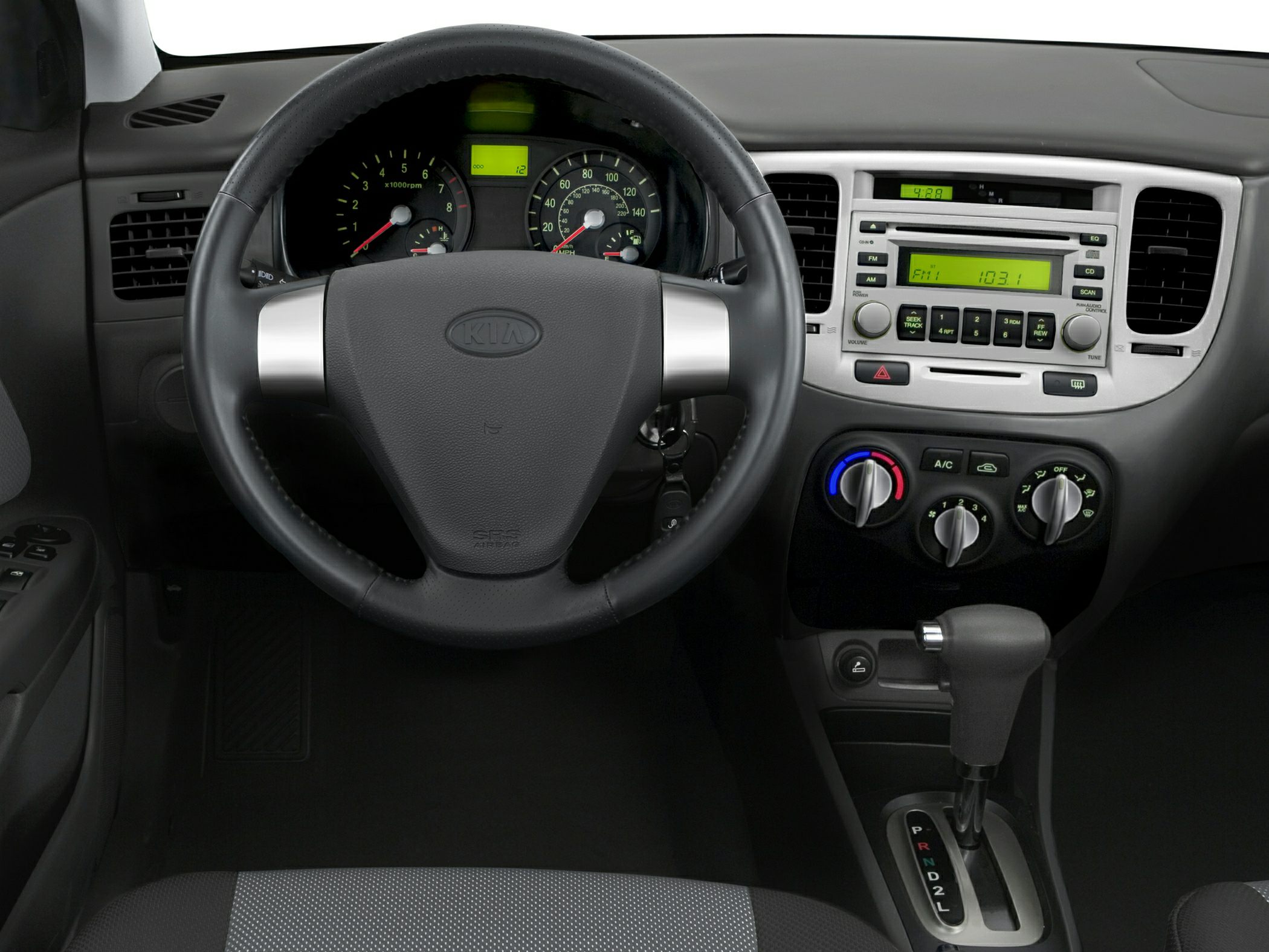 Steering wheel, instrument cluster, and center console with climate and audio controls.